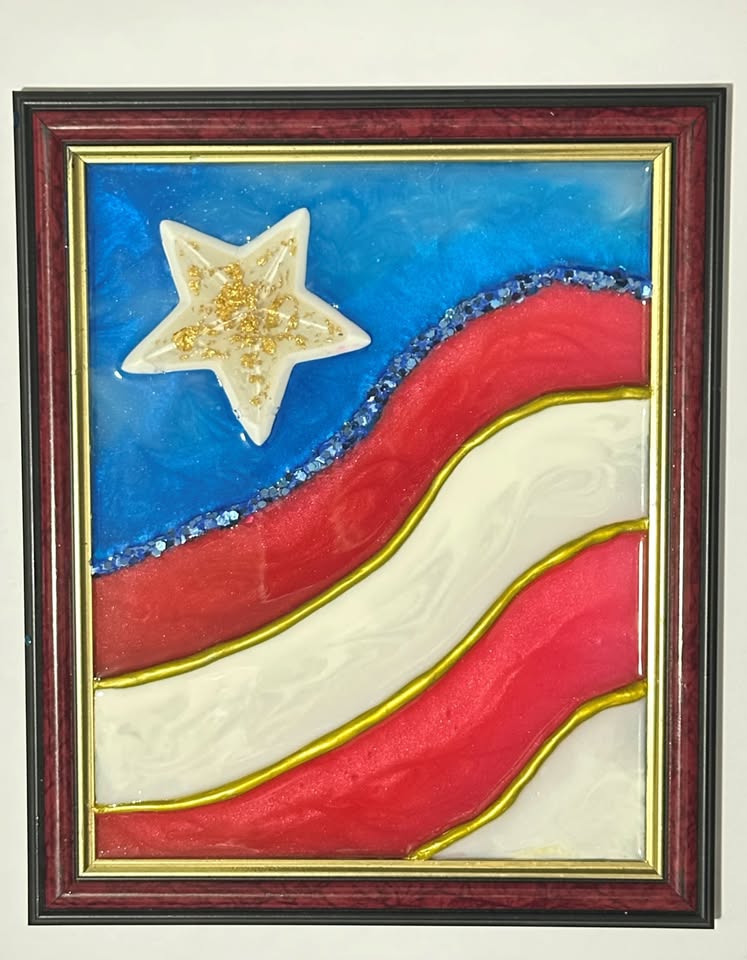 A smaller stylized USA flag art piece in a frame with blue, red and white stripes and stars